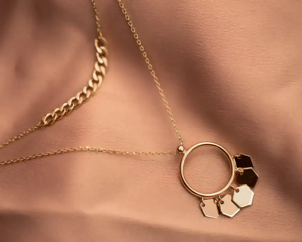 Delicate gold necklaces laid out on a soft surface