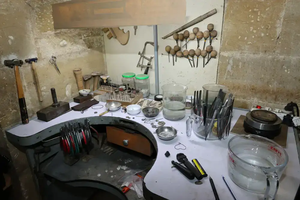 Jeweller's workbench with raw gold elements and tools